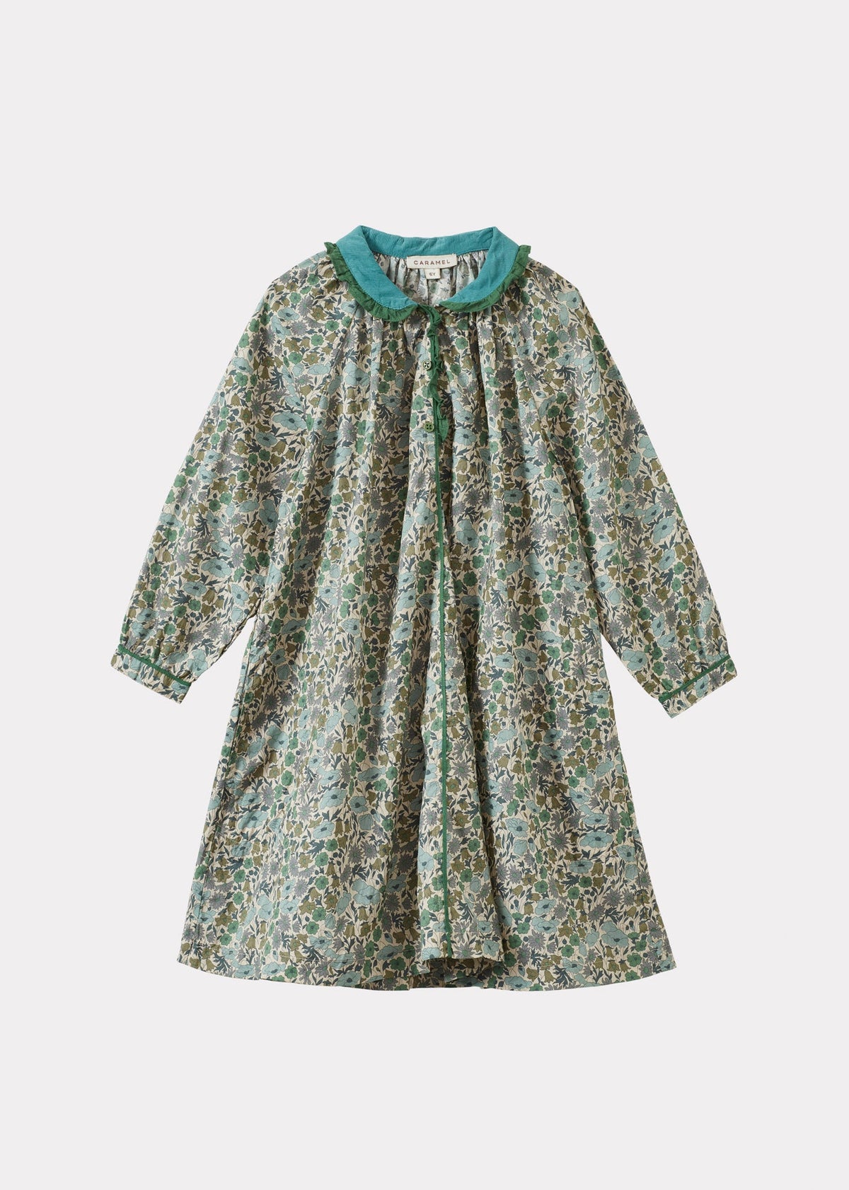 A long-sleeve babydoll dress with a green and beige floral print, featuring a contrasting teal collar and buttoned front, shown against a light gray background.